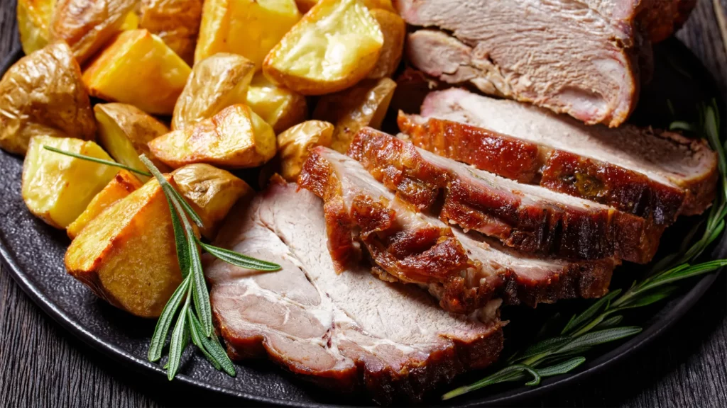 Roast pork with dried plums and baked potatoes